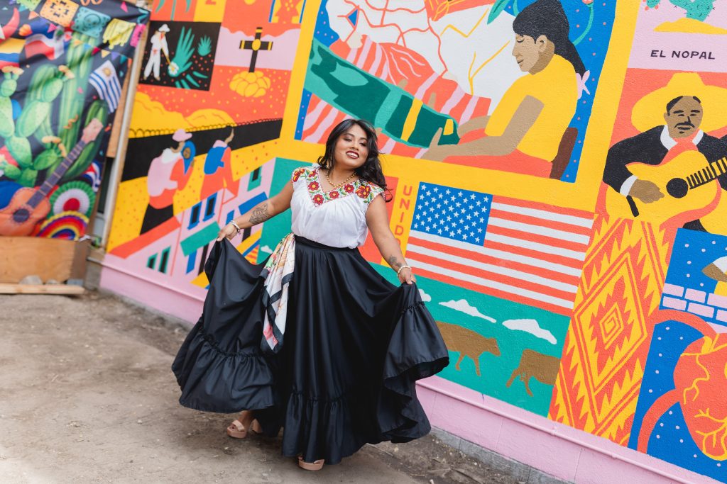 Yamel dancing in front of the 'Corner of Mexico' mural. Photo by Mariel Wiley.