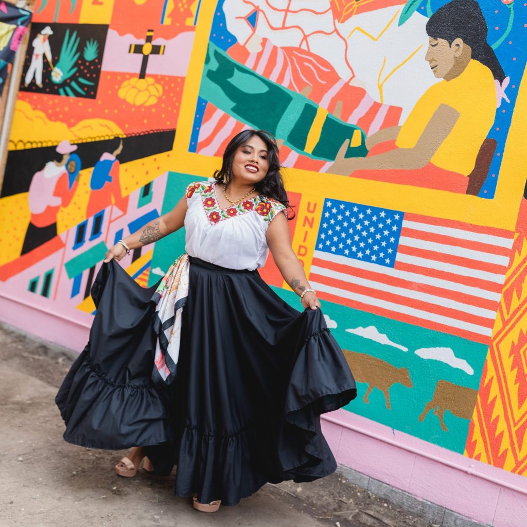 Yamel dancing in front of the 'Corner of Mexico' mural. Photo by Mariel Wiley.